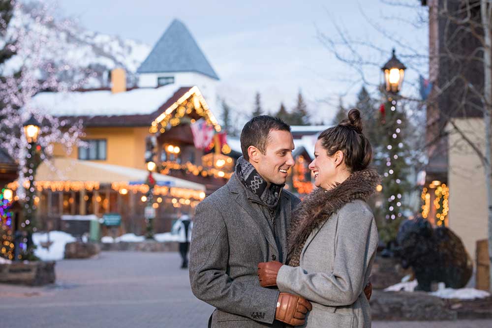 Couple in Vail Village in winter. Vail lodging